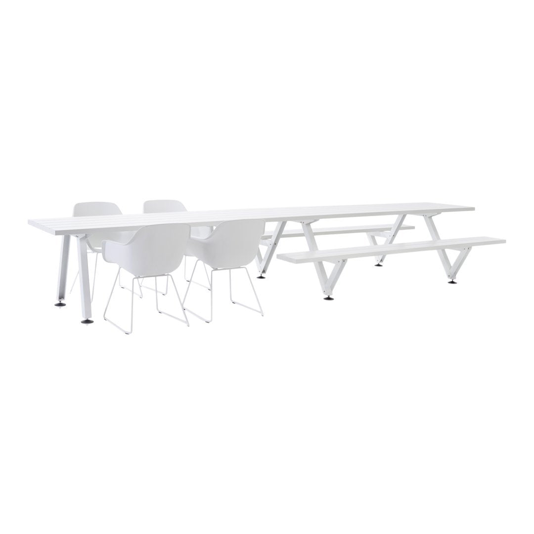 White sleek picnic table and chairs with a minimalist design, featuring smooth surfaces and geometric patterns.