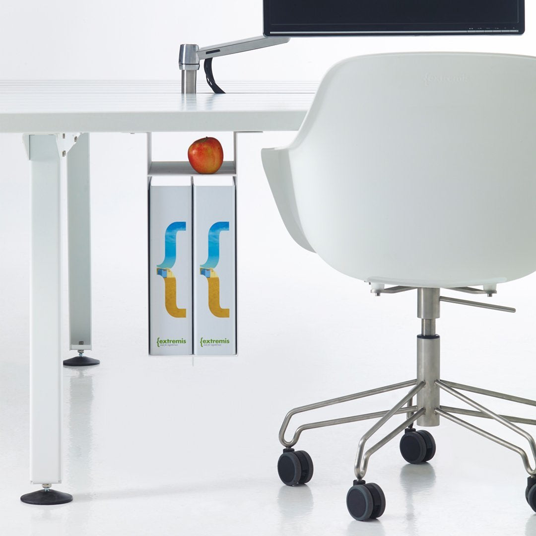 White desk with gray accents, featuring a sleek silver organizer with colorful blue and orange design, alongside a red apple.