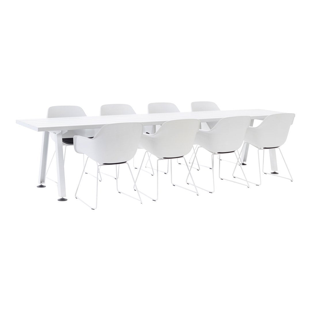 "Modern white dining table with matching white chairs, featuring clean lines and a minimalist design."
