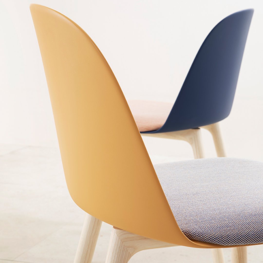 "Modern chair featuring soft yellow, navy blue, and textured light blue upholstery for a contemporary look."