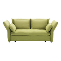 Green fabric sofa with a modern design and plush, oversized cushions, ideal for contemporary living spaces.