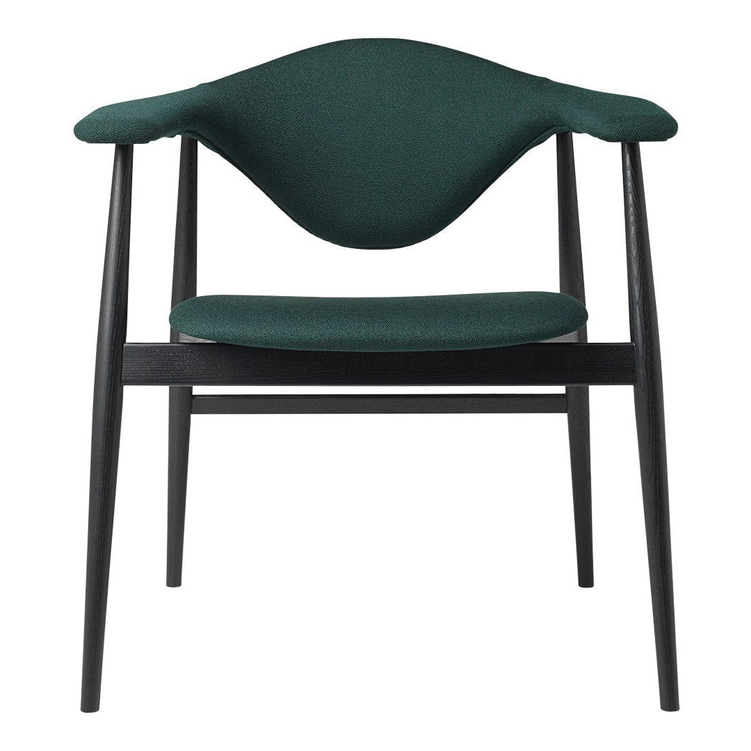 "Green upholstered chair with a sleek black frame, featuring a smooth, curved backrest."