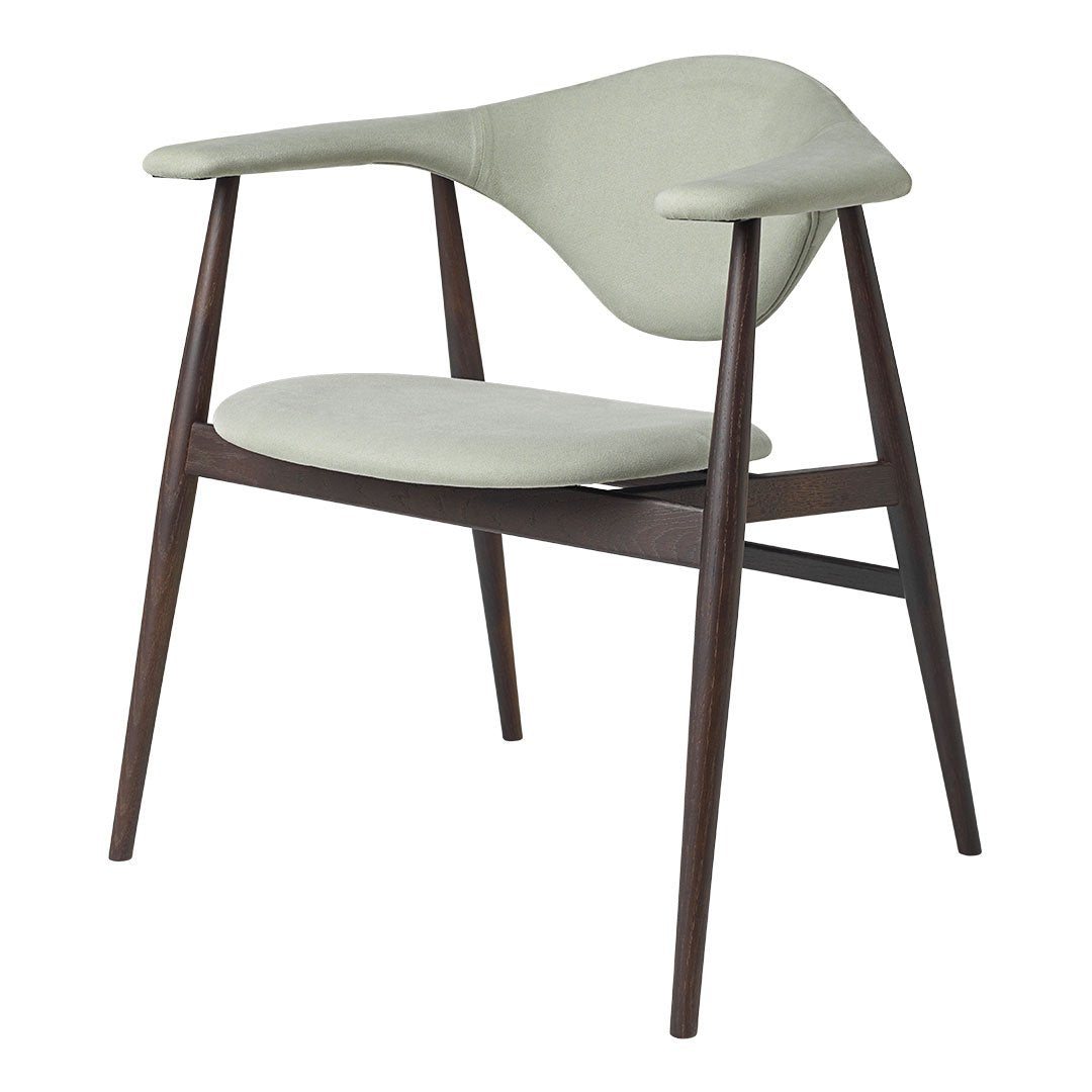 Light green upholstered chair with smooth curves and dark wood legs, perfect for modern decor.