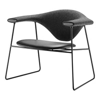 Modern black chair with a sleek, curved design and textured gray fabric upholstery, featuring minimalist wire legs.
