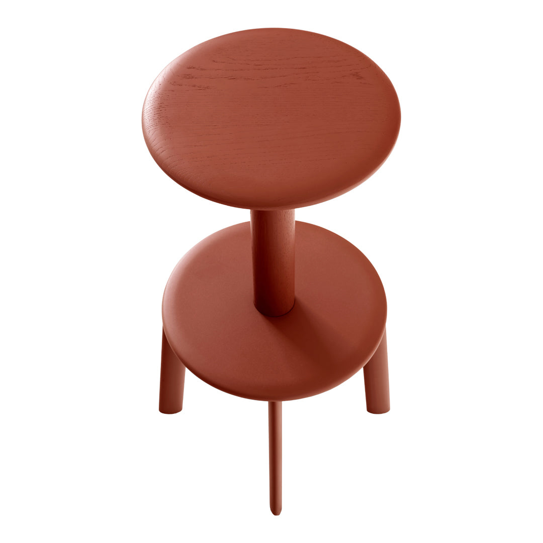 Two-tier side table in warm terracotta with smooth, circular tops and slender legs. Modern and minimalist design.