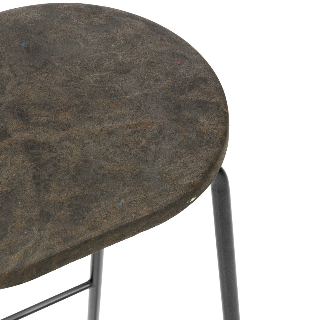 Round, textured gray stool top with subtle dark patterns, paired with black metal legs. Ideal for modern decor.