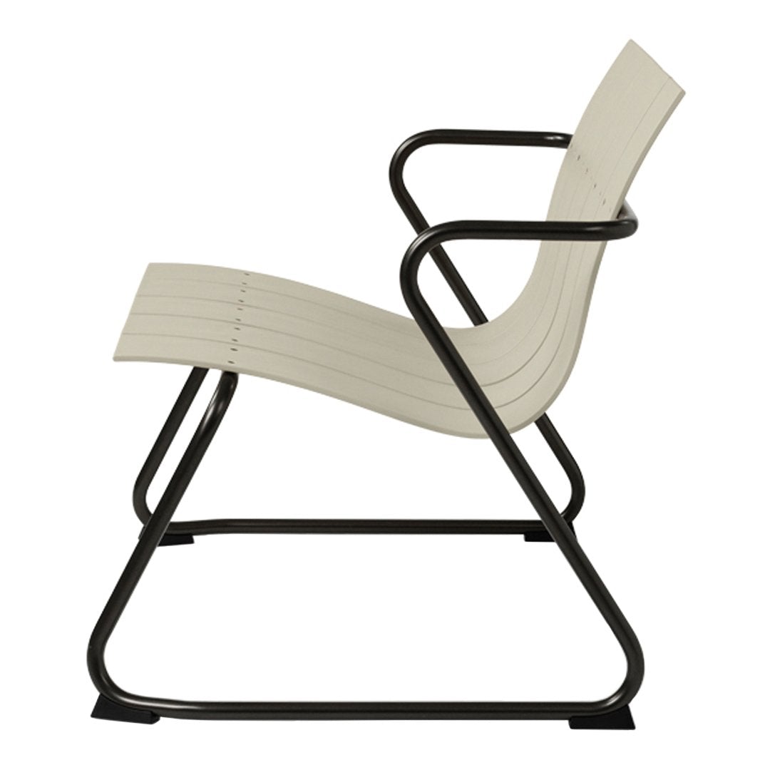 Cream-colored lounge chair with sleek black metal frame and minimalist striped design. Perfect for modern decor.
