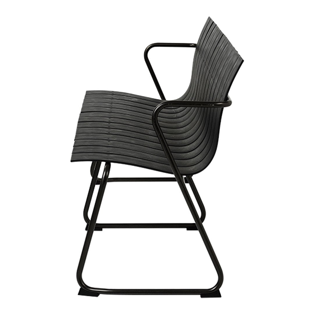 Black striped chair with a sleek design and matte black metal frame, showcasing modern minimalist aesthetics.