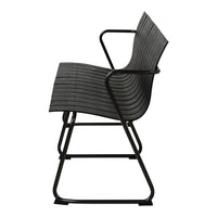 Black striped chair with a sleek design and matte black metal frame, showcasing modern minimalist aesthetics.