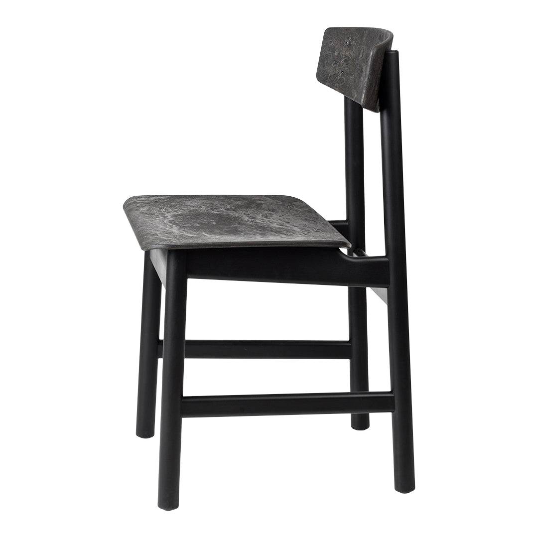 Black wooden chair with a textured seat and back, showcasing subtle patterns in a modern design.