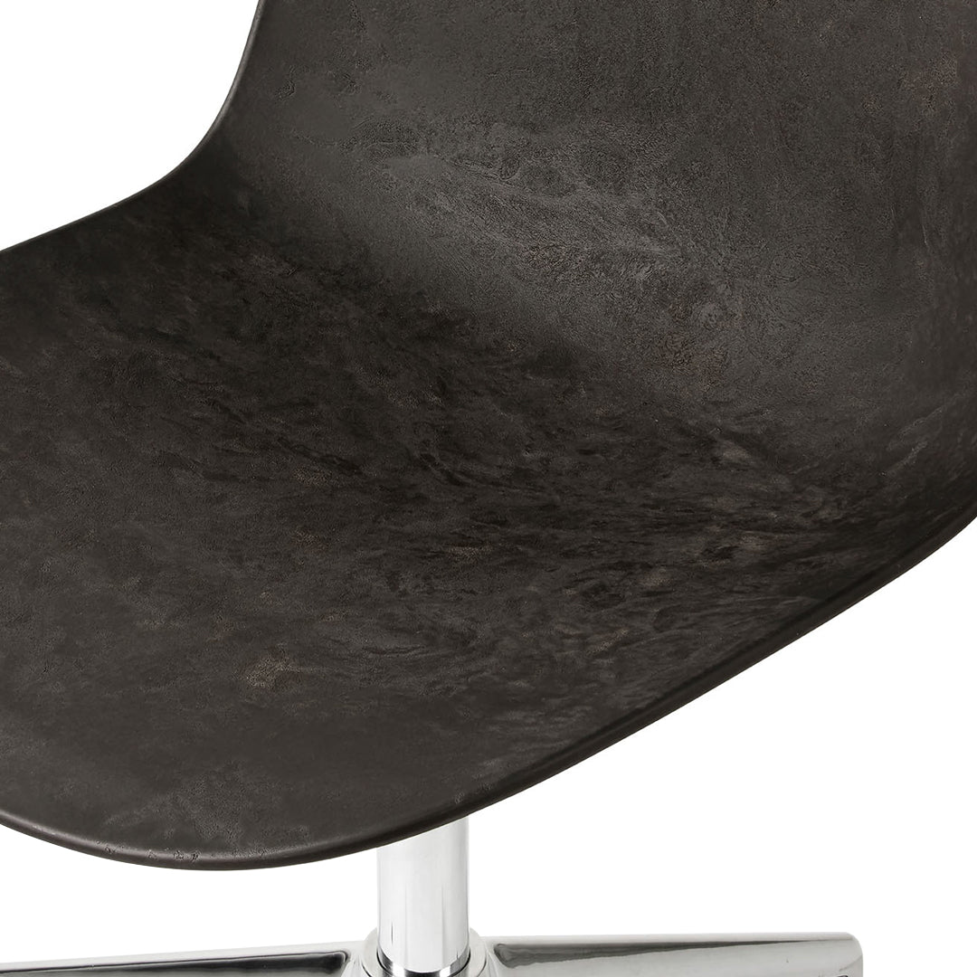 Black textured chair seat with subtle patterns and a shiny chrome base. Modern design element for any space.