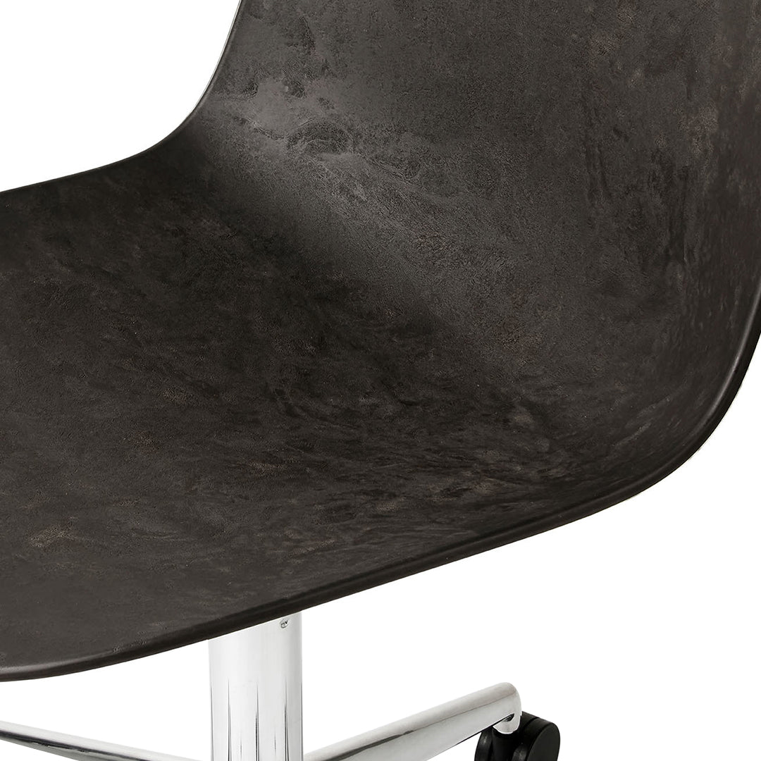 Black textured chair seat with a glossy chrome base. Modern design with sleek, minimalist appeal.