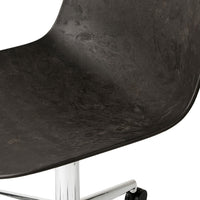 Black textured chair seat with a glossy chrome base. Modern design with sleek, minimalist appeal.