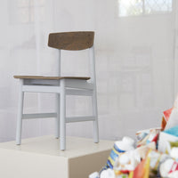 Gray and brown wooden chair with a simple design, set against a light, neutral background.