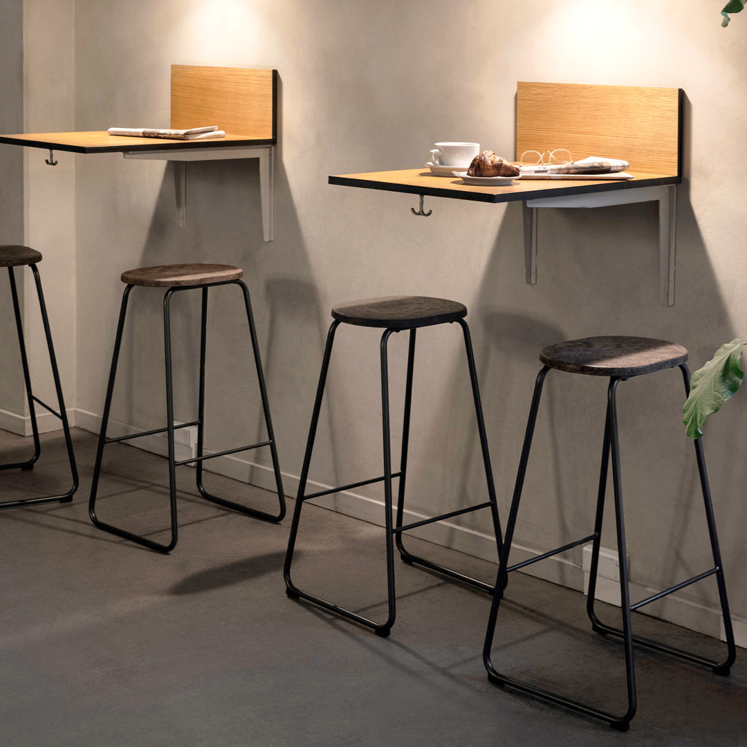 Modern bar stools with black metal frames and wooden seats, paired with natural wood wall-mounted tabletops.