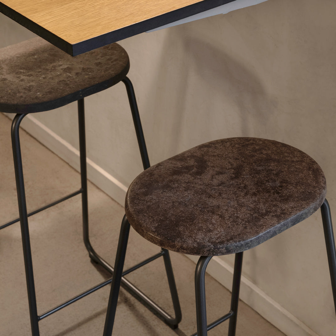 "Stylish brown upholstered bar stools with sleek black metal frames, featuring soft, textured surfaces."