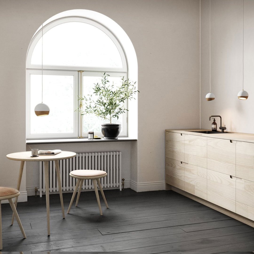 Modern Scandinavian kitchen with light wood tones, soft beige walls, and dark gray flooring. Clean lines and minimal patterns.