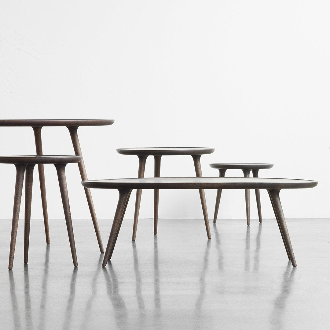 "Set of modern coffee tables in rich wood tones with smooth, minimalist surfaces and tapered legs."