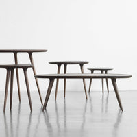 "Set of modern coffee tables in rich wood tones with smooth, minimalist surfaces and tapered legs."