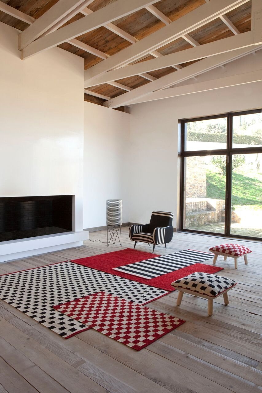 Red and black checkered patterns on rugs, creating a stylish contrast against a modern living space.