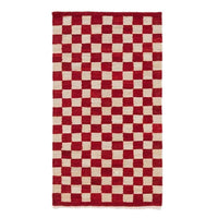 Red and beige checkered pattern area rug, featuring contrasting squares for a bold, stylish look.
