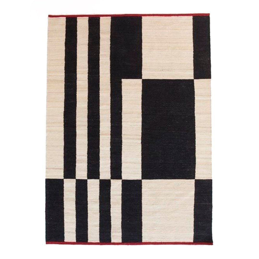 Black and cream geometric pattern rug with a red border, featuring bold stripes and rectangles. 