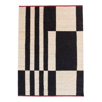 Black and cream geometric pattern rug with a red border, featuring bold stripes and rectangles. 