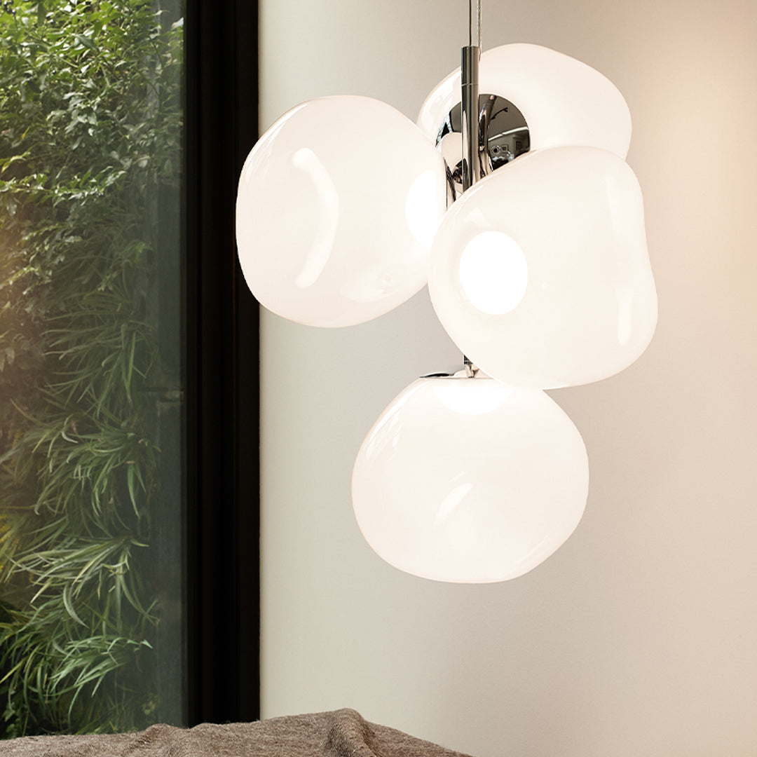 White, glossy pendant light with a fluid, organic shape, featuring a chrome base for a modern touch.
