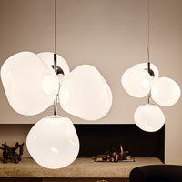 White organic-shaped pendant lights with glossy finish, featuring a modern, minimalist design and playful arrangement.
