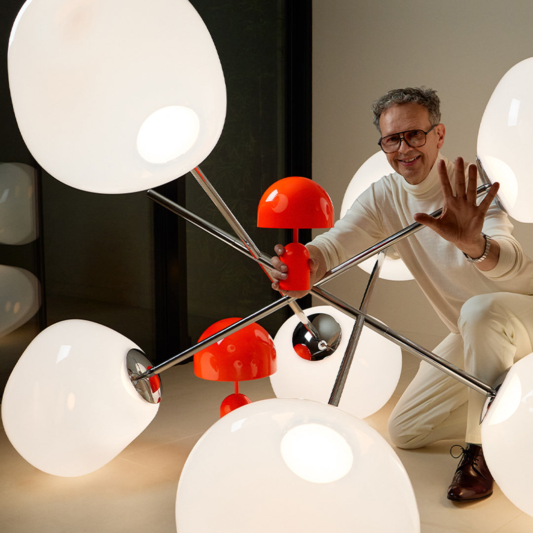 Modern lamp design featuring glossy white orbs and vibrant orange accents, creating a playful yet elegant aesthetic.