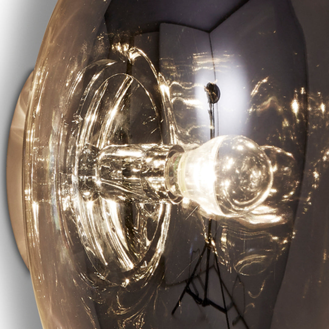Close-up of a clear glass bulb with a sleek, modern design showcasing reflections and subtle textures.