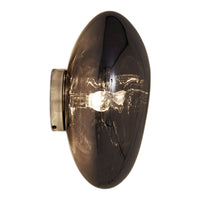 Sleek, oval black glass wall sconce with a smoky finish and metallic accents. Modern design for elegant lighting.