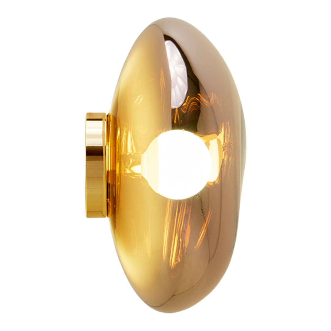 Sleek gold wall light with a smooth oval shape, reflecting light and showcasing a shiny metallic finish.