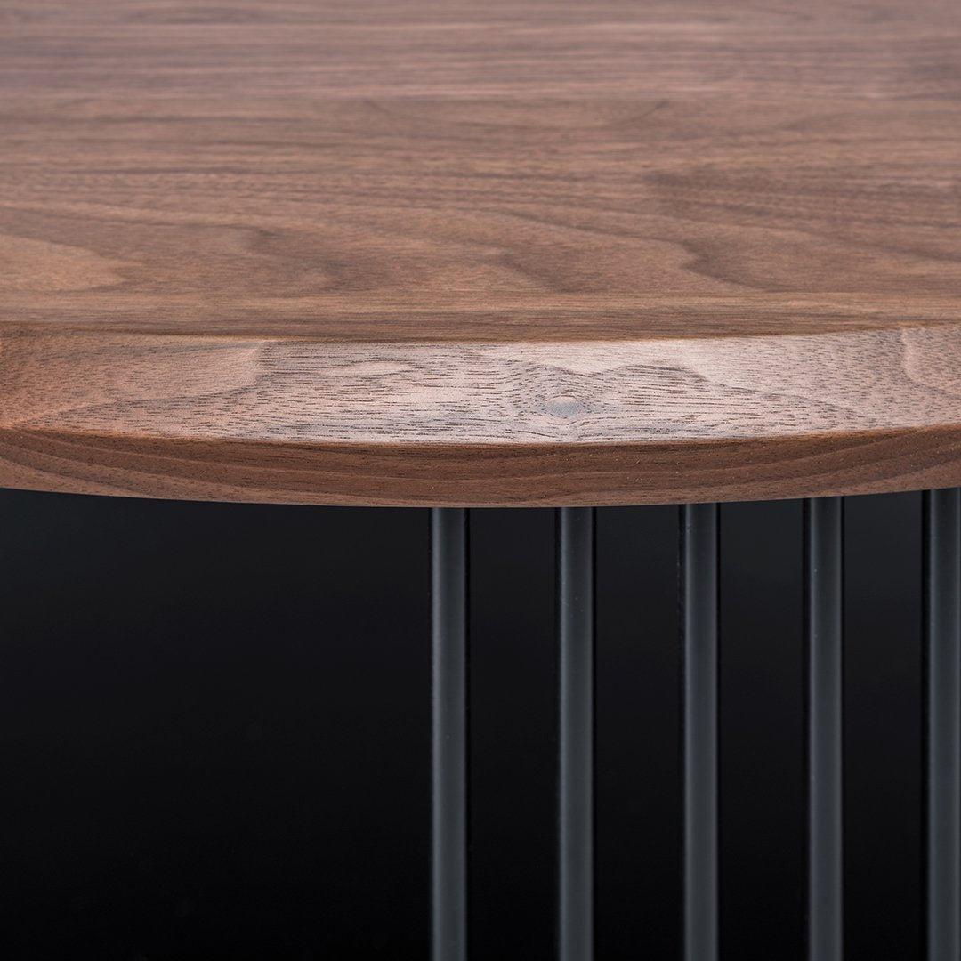 Walnut wood top with rich brown tones, featuring smooth, natural grain. Black metal legs create a modern contrast.