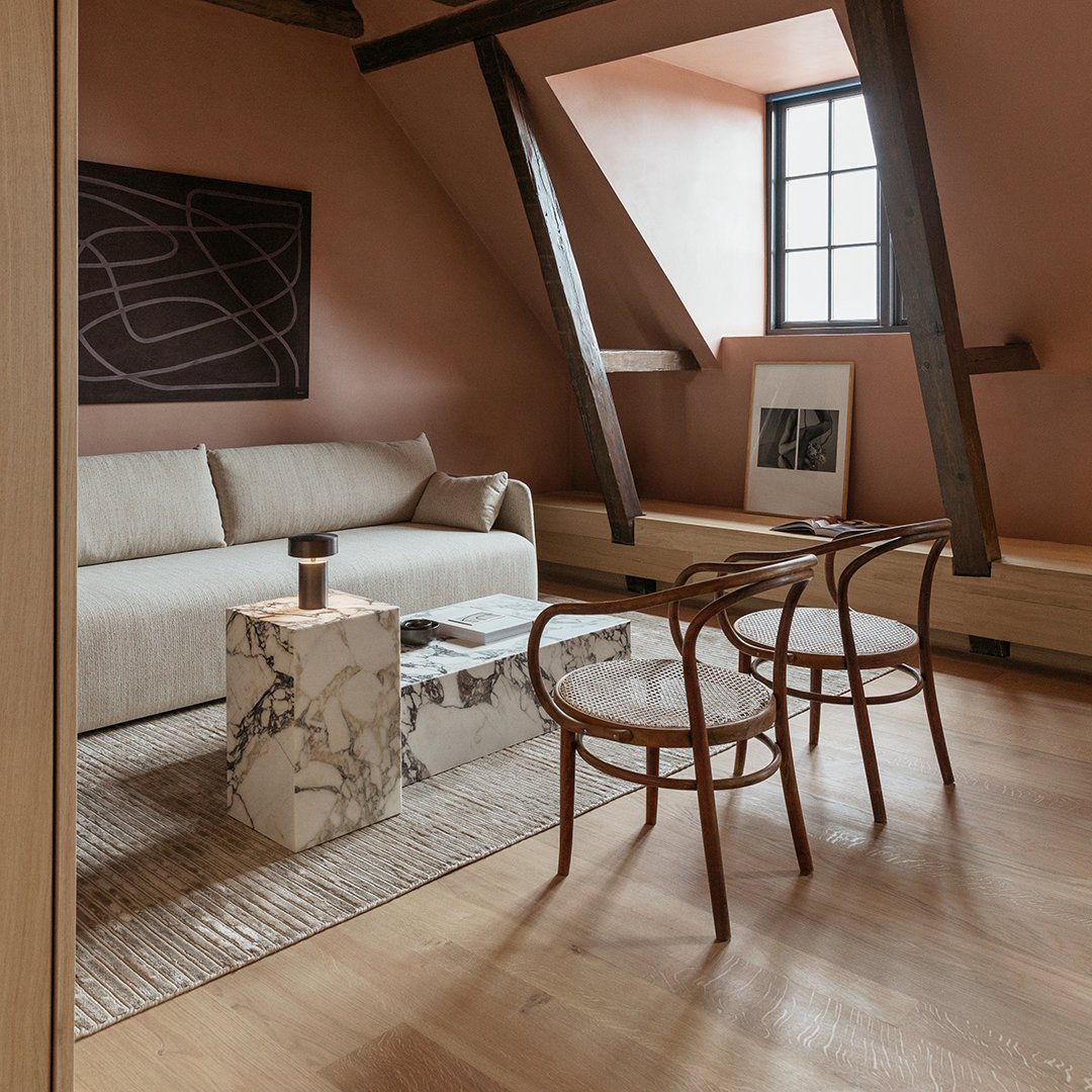 "Modern living room with neutral beige tones, marble patterns, and wooden accents creating a warm, inviting atmosphere."