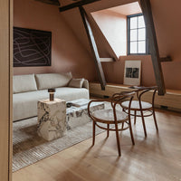 "Modern living room with neutral beige tones, marble patterns, and wooden accents creating a warm, inviting atmosphere."