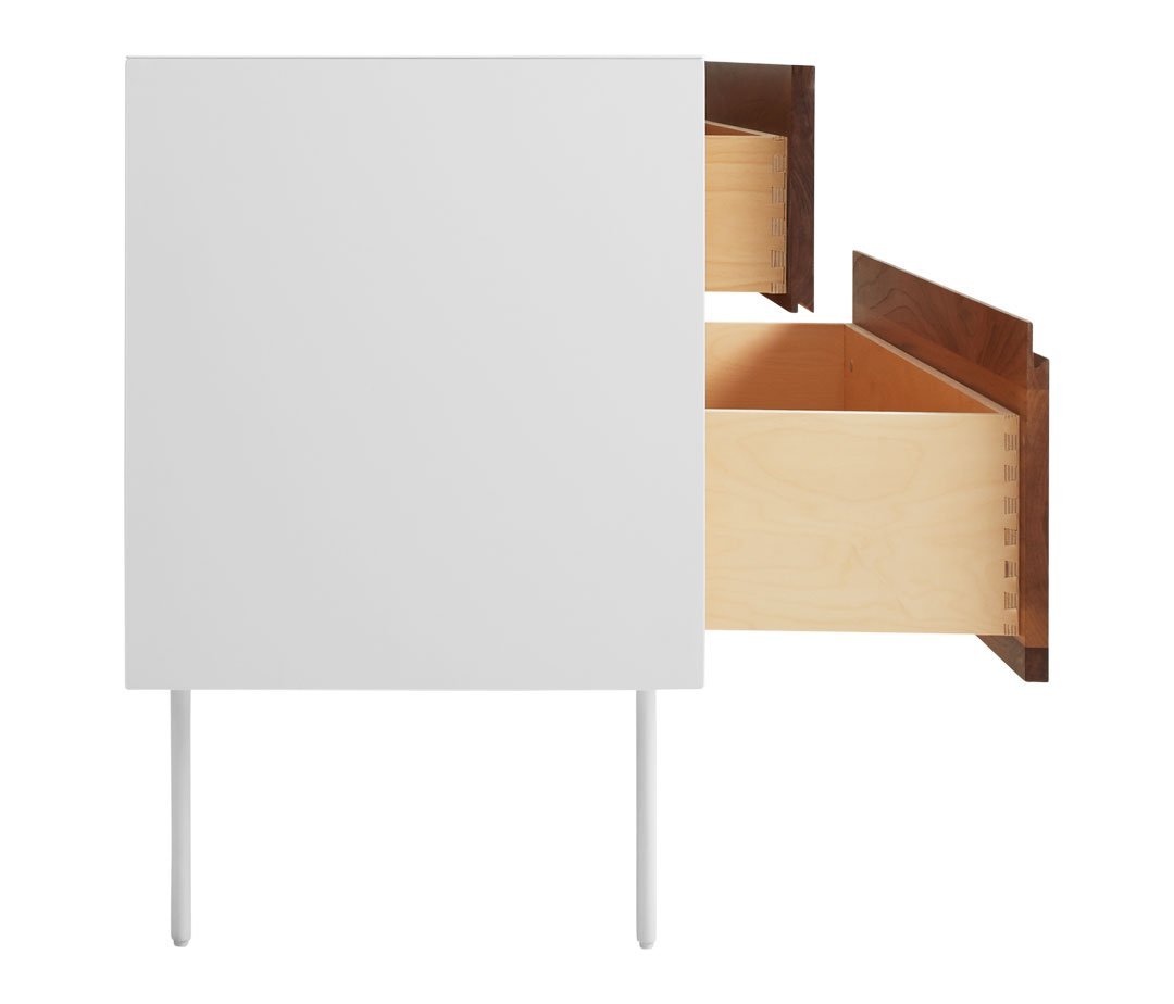 White minimalist cabinet with natural wood drawer and sleek metal legs, showcasing a modern design aesthetic.
