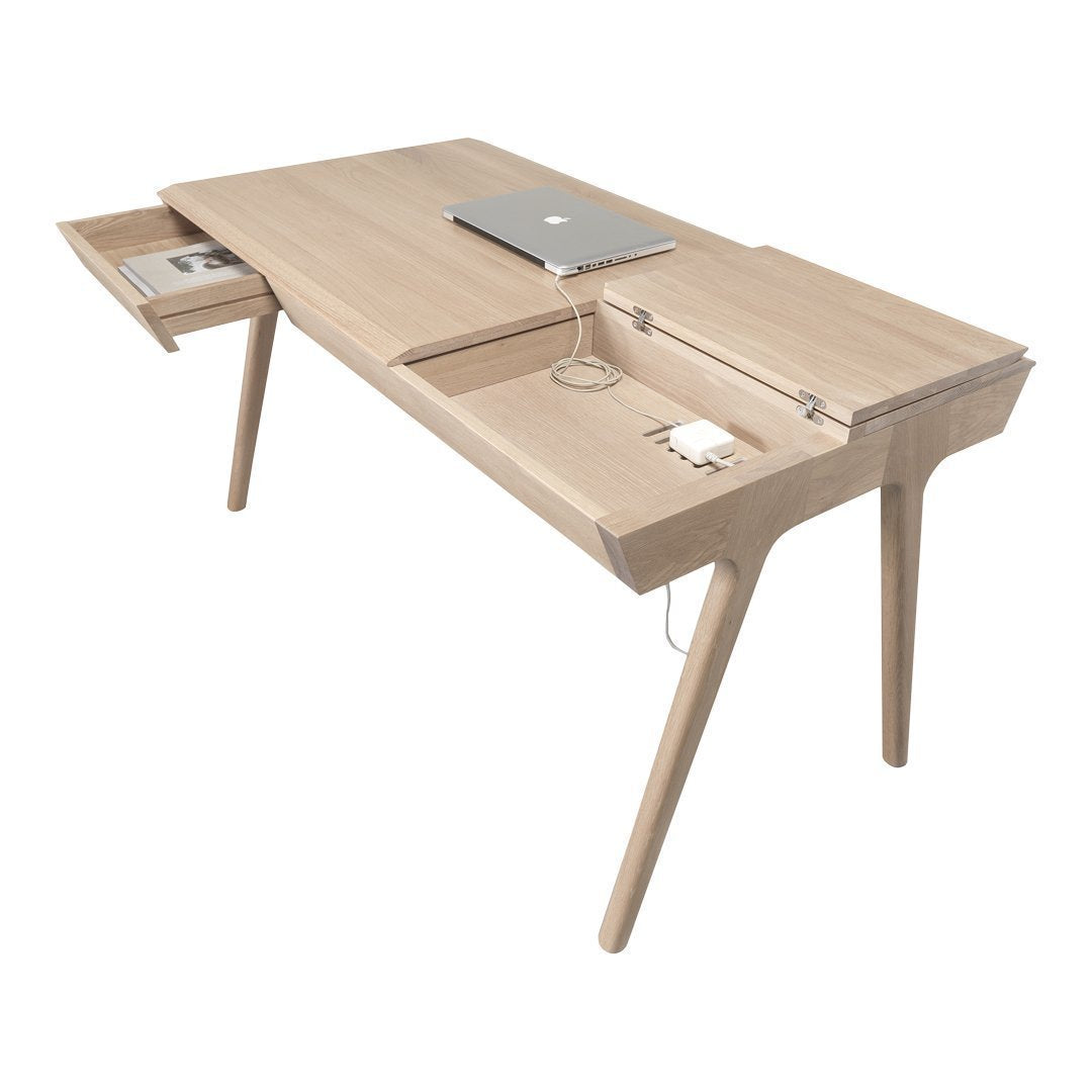 Light oak wood desk with sleek, minimalist design featuring a smooth surface and tapered legs.