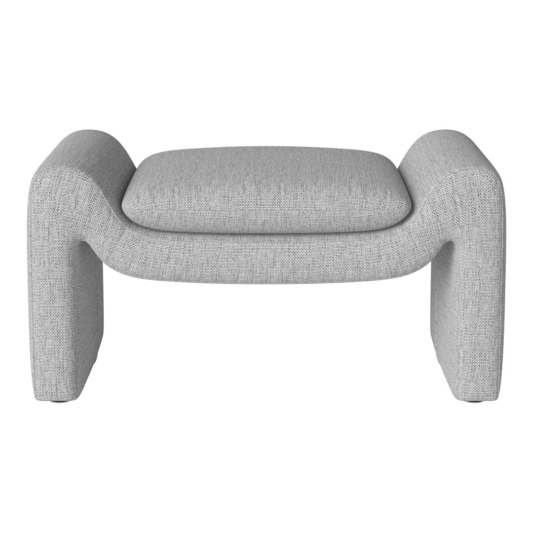 Gray textured ottoman with a minimalist design, featuring soft curves and a smooth finish. Perfect for modern decor.