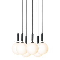 Modern pendant light with six white glass globes and sleek black fixtures, suspended on minimalistic black cords.
