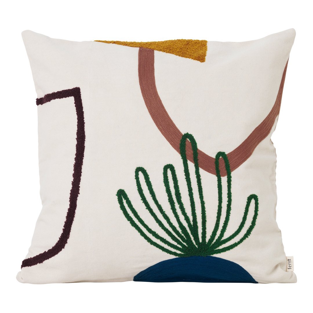 Cream pillow featuring abstract green, brown, and navy patterns with geometric shapes and plant designs.
