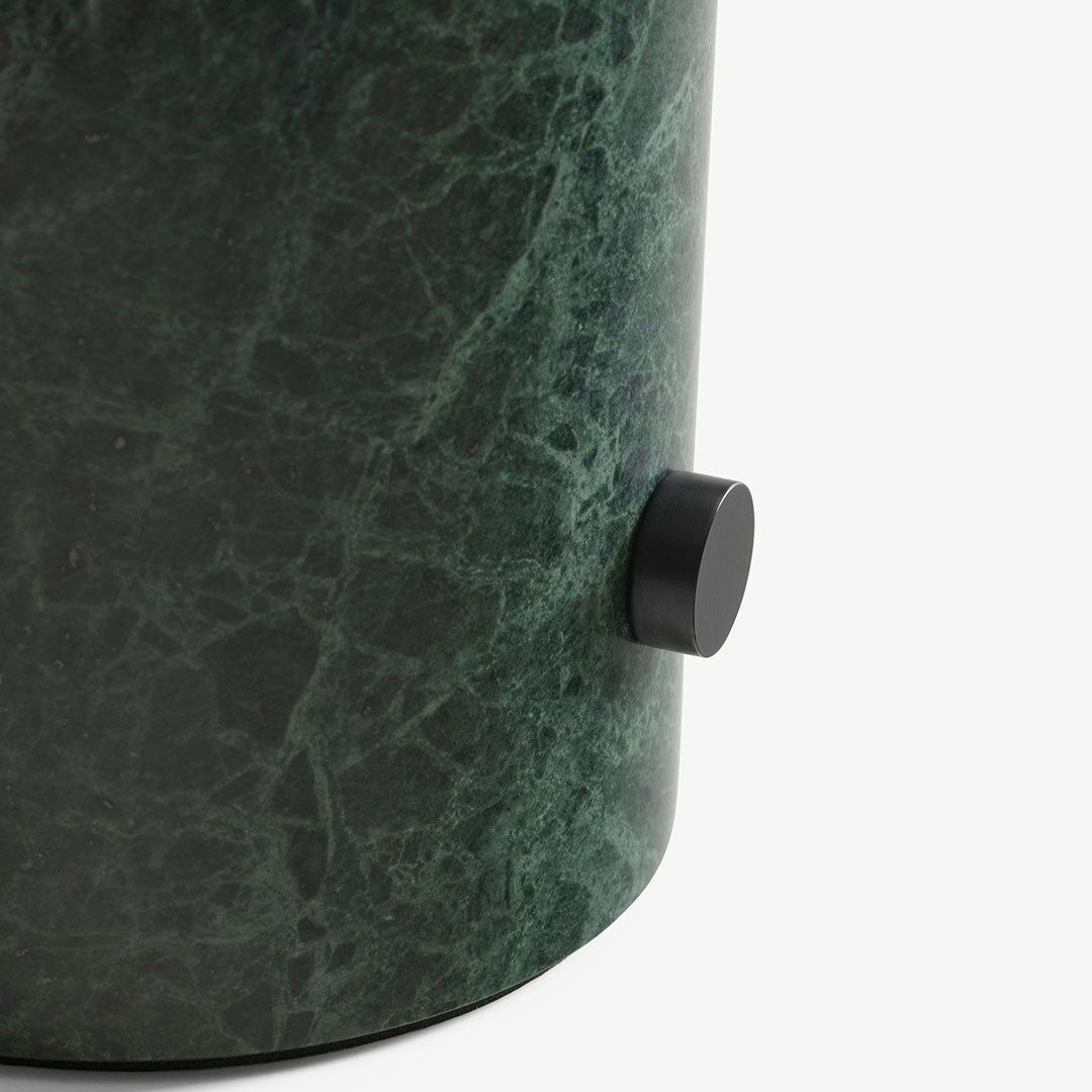 Green marble pattern with a smooth texture, featuring a contrasting black knob for added detail.