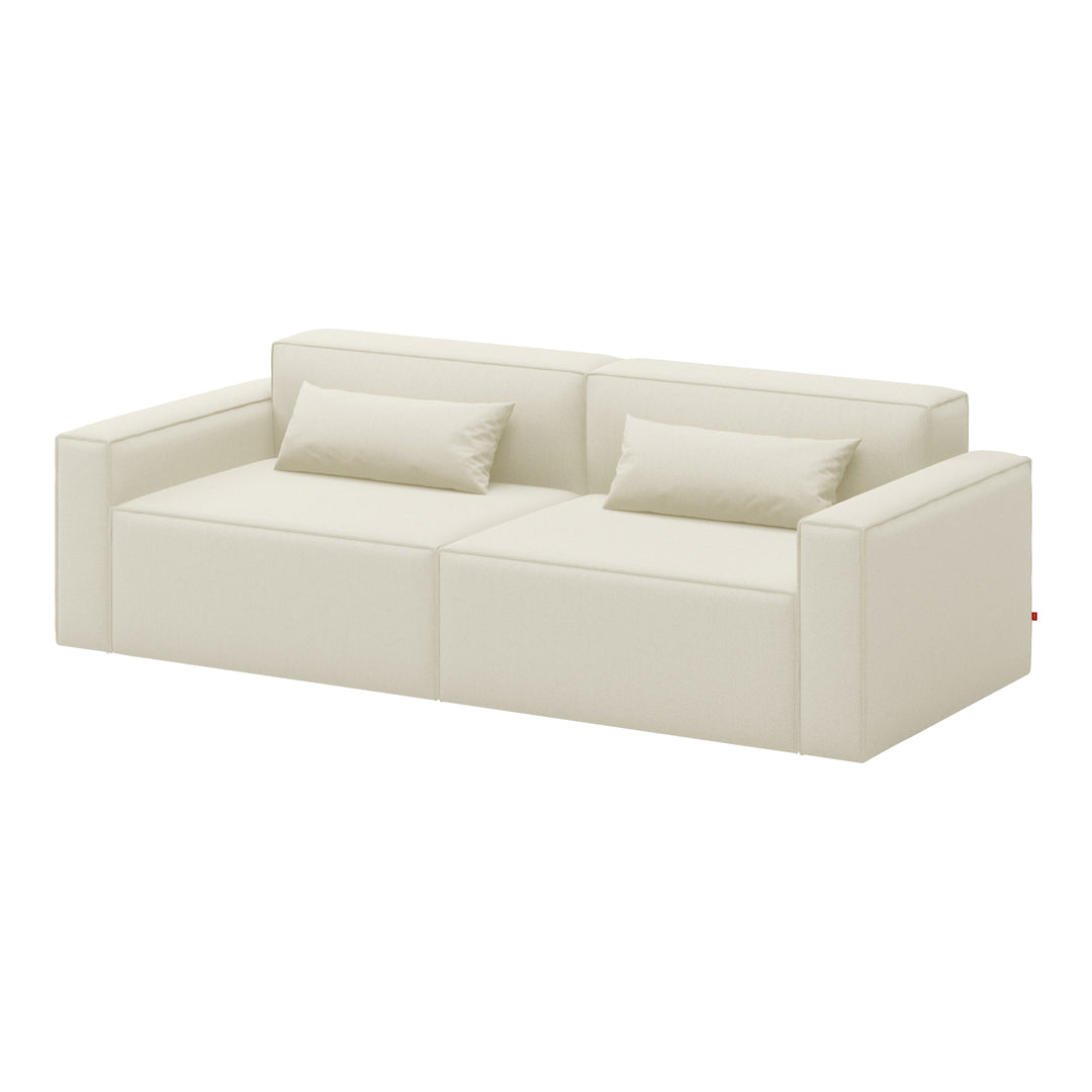 Cream-colored sofa with a smooth, solid surface and square cushions for a modern minimalist aesthetic.