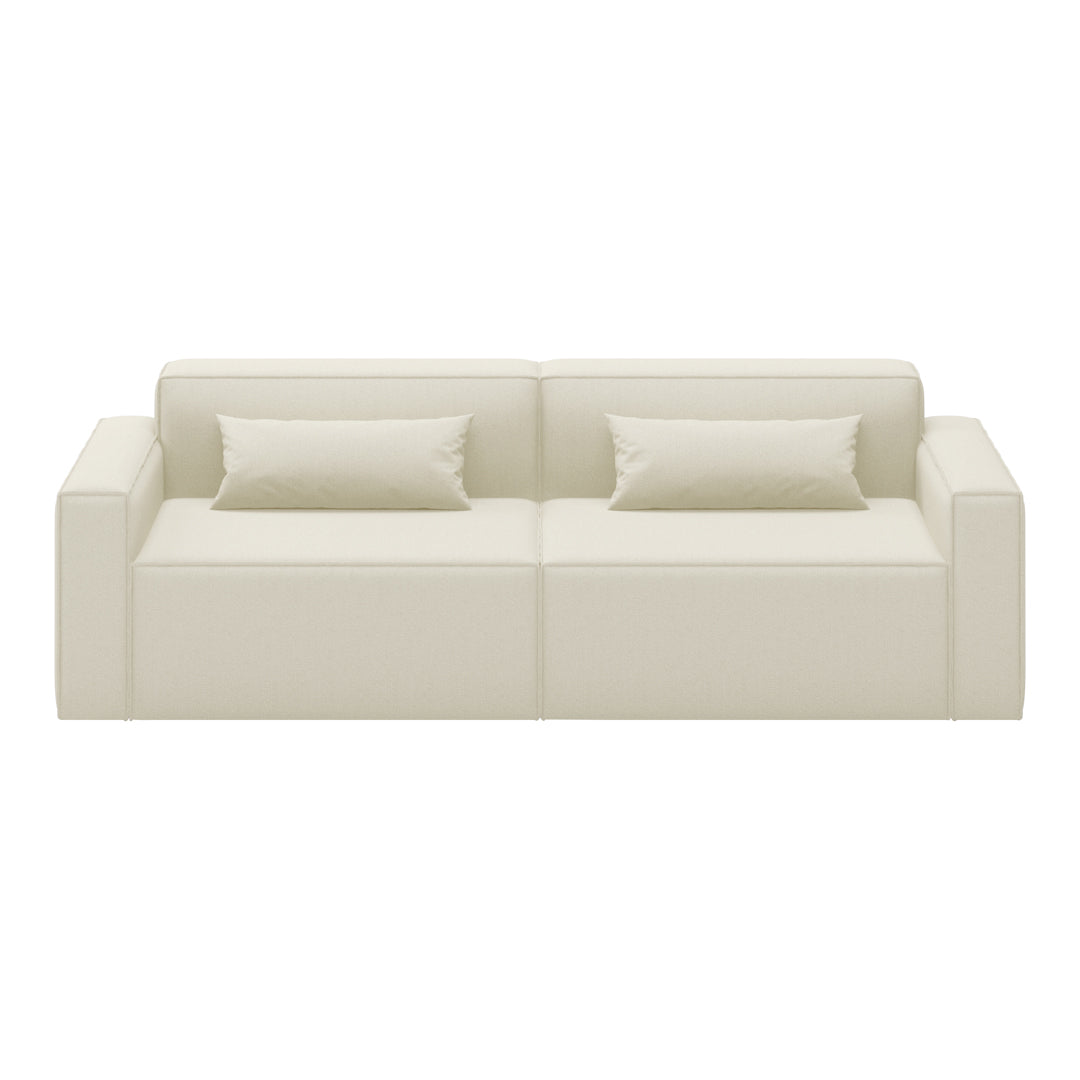 Cream-colored minimalist sofa with smooth upholstery and two matching cushions. Perfect for modern living spaces.