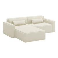 Cream-colored sectional sofa with a minimalist design and smooth, solid fabric upholstery.