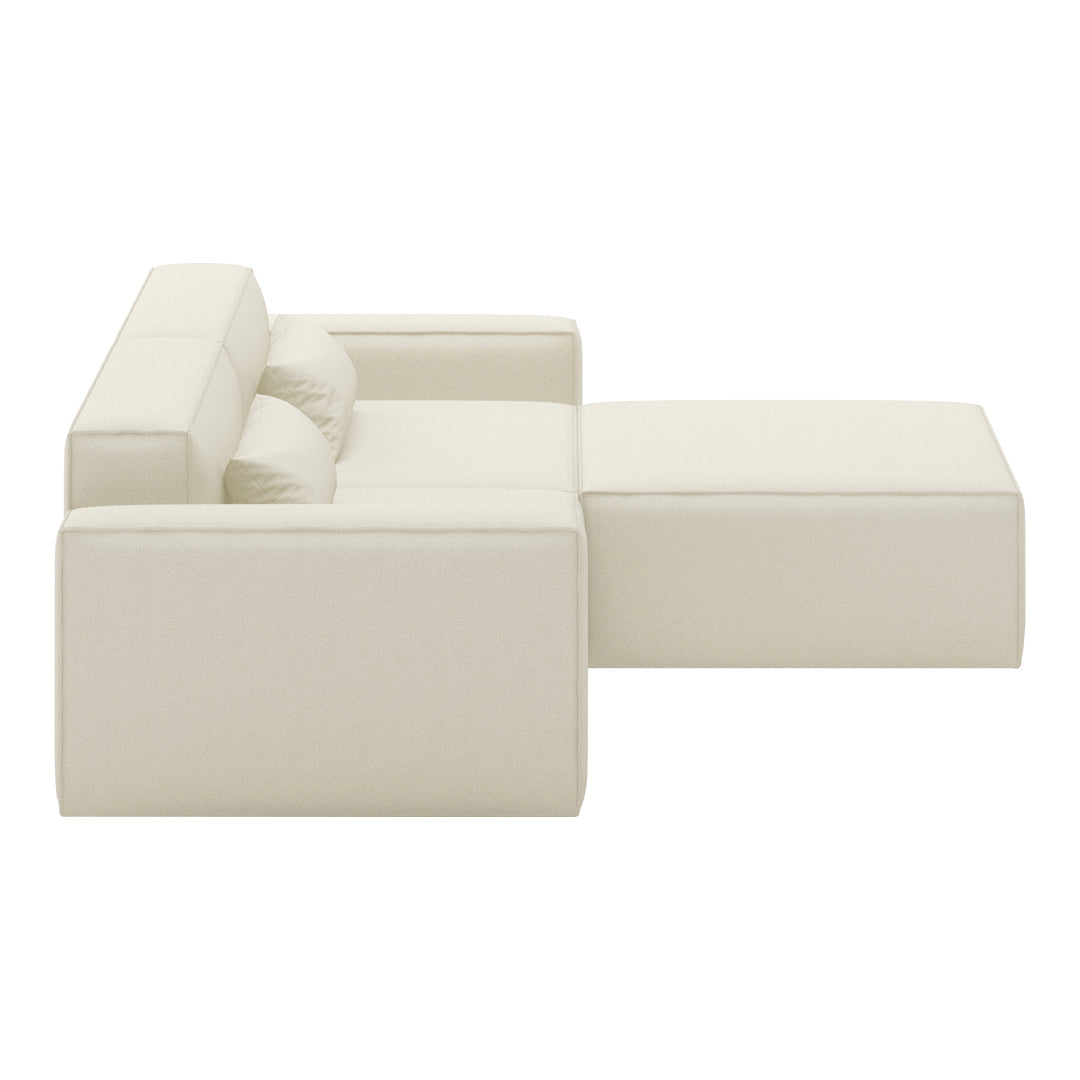 Cream-colored sectional sofa with a minimalist design, featuring smooth, clean lines and no visible patterns.