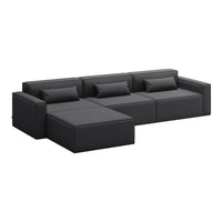 Black leather sectional sofa with clean lines and smooth texture, featuring plush cushions for comfort.