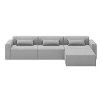 "Modern gray sectional sofa with clean lines and soft fabric, featuring multiple seating sections and matching pillows."