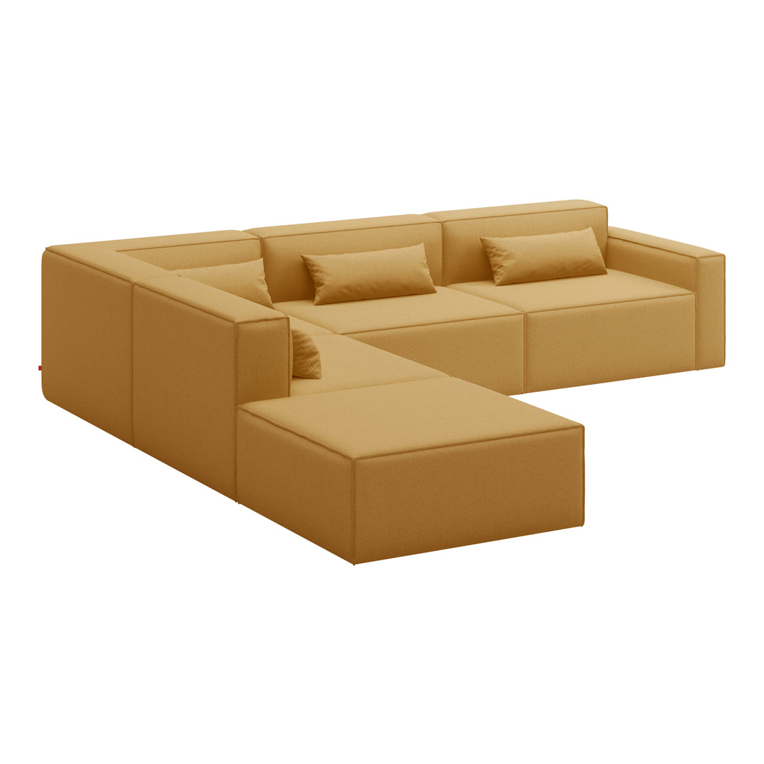 L-shaped sofa in warm mustard yellow with smooth texture and minimalist design, featuring plush cushions.