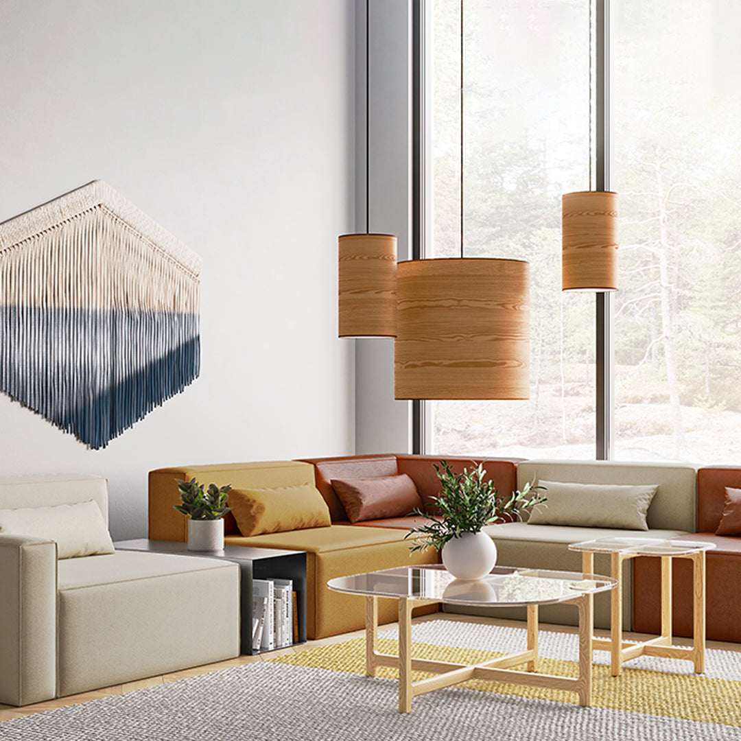 Modern living room featuring neutral beige and warm brown tones with geometric wall art and natural wood accents.